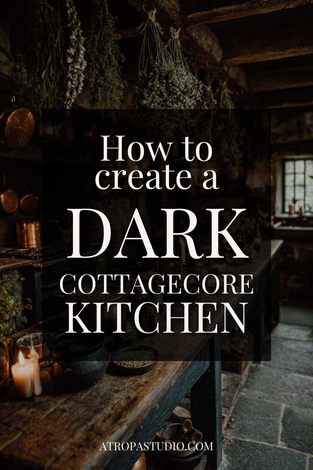 Dark cottagecore kitchen with dried herb bundles hanging from wooden ceiling beams, copper pots, black cast iron bowls, and candlelight on a stone floor